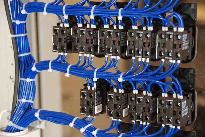 Figure 2: Additional control panel construction time is required when wiring is bundled to door-mounted devices because wires must not restrict opening and closing the door. Courtesy: Eaton