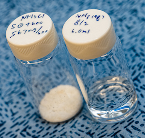 Ammonium chloride, at left, and liquid ammonia are the products of a catalyst developed by engineers at Rice University to convert wastewater into useful chemicals. Photo by Jeff Fitlow. Courtesy: Rice University.