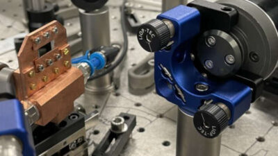 The semiconductor nanosheets in the water-cooled copper mount turn an infrared laser pulse into an effectively unipolar terahertz pulse. The team says that their terahertz emitter could be made to fit inside a matchbox. Credit: Christian Meineke, Huber Lab, University of Regensburg. Courtesy: University of Michigan.