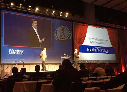 Kris Dornan (right) speaks about Rockwell's Studio 5000 connected enterprise software at the keynote speech at Rockwell Automation Fair. Courtesy: CFE Media
