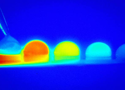In a time-lapse sequence, infrared imaging shows the temperature changes within a droplet of water as it moves across a treated silicon surface in response to temperature differences on that surface. Courtesy: N. Bjelobrk/Varanasi Research Group, MIT News