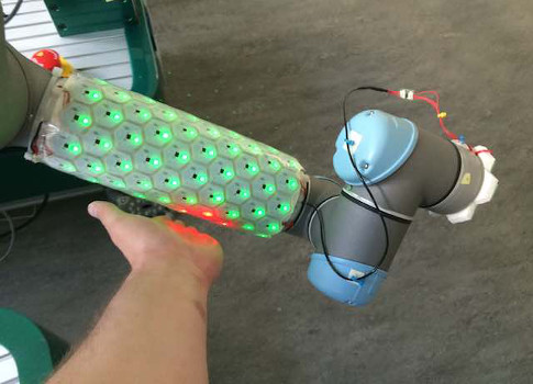 Figure 4: ROS-based motion planners reroute the arm when obstacles are encountered. A Universal Robots UR5 (up to 5 kg payload) was used in the sensory skin project mentioned. Courtesy: ROS-Industrial, Factory-in-a-day project