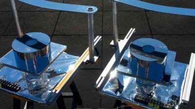 Two versions of the device designed by MIT researchers, using a strip of metal to block direct sunlight, were built and tested on the roof of an MIT building to confirm that they could provide cooling well below ambient air temperature. Courtesy: Bikram Bhatia, MIT
