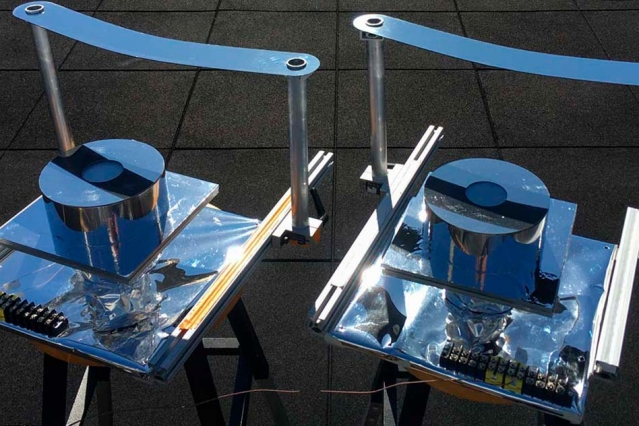 Two versions of the device designed by MIT researchers, using a strip of metal to block direct sunlight, were built and tested on the roof of an MIT building to confirm that they could provide cooling well below ambient air temperature. Courtesy: Bikram Bhatia, MIT