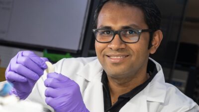 Rice University research scientist M.M. Rahman holds a flexible dielectric made of a polymer nanofiber layer and boron nitride. The new material stands up to high temperatures and could be ideal for flexible electronics, energy storage and electric devices where heat is a factor. Courtesy: Jeff Fitlow/Rice University
