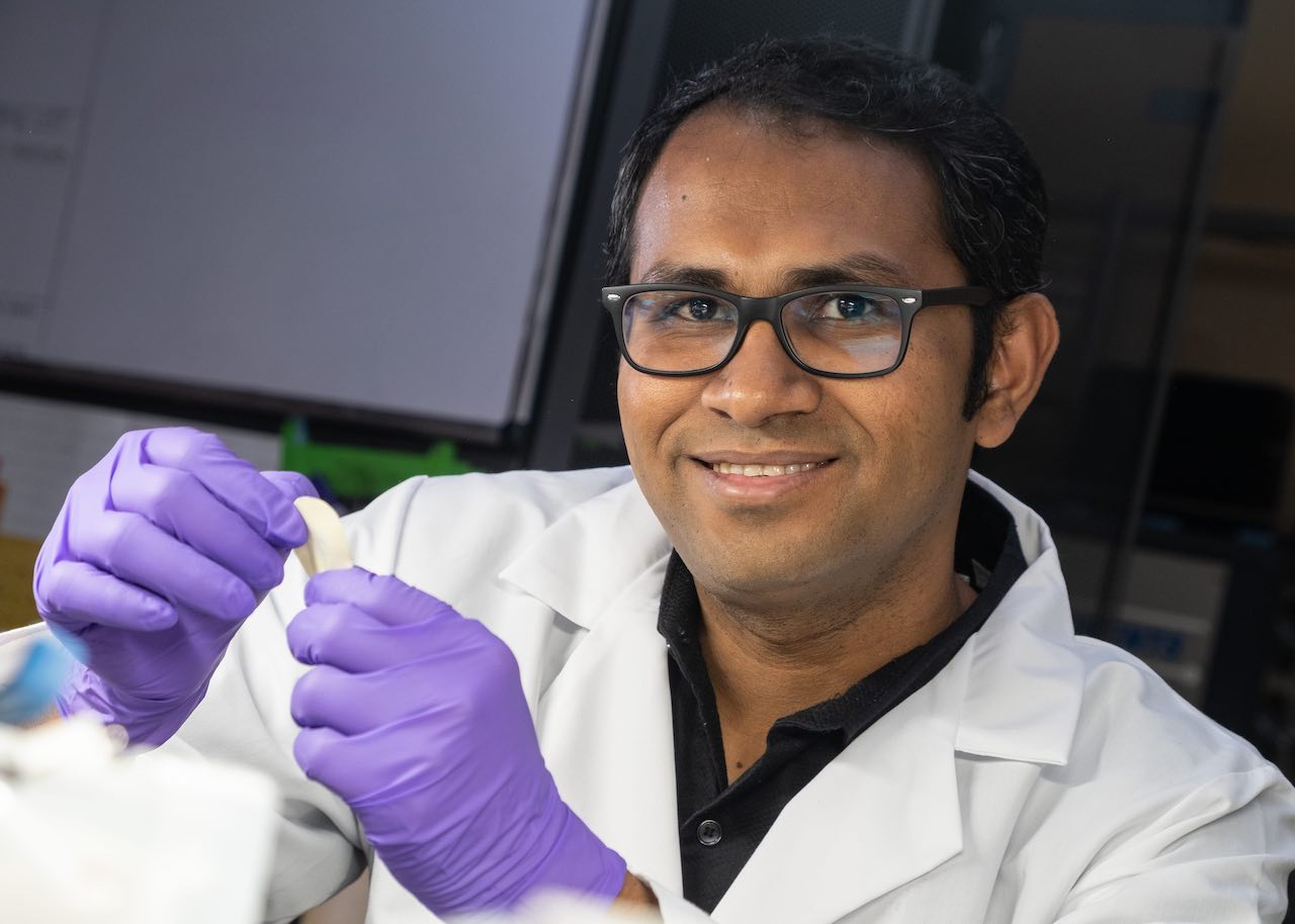 Rice University research scientist M.M. Rahman holds a flexible dielectric made of a polymer nanofiber layer and boron nitride. The new material stands up to high temperatures and could be ideal for flexible electronics, energy storage and electric devices where heat is a factor. Courtesy: Jeff Fitlow/Rice University