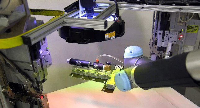 After the male and female snaps have been inserted, the UR5 places the fabric under a vision camera lens for quality inspection and sorts it in either a “good” or “reject” pile. Courtesy: Universal Robots