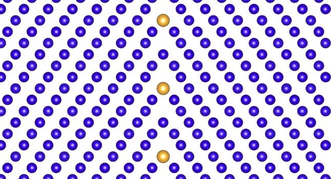 Two iterations of a metal lattice meet at a “grain boundary” defect, with atoms of an alloying element fitting into the defect. Courtesy: Liang Qi, University of Michigan