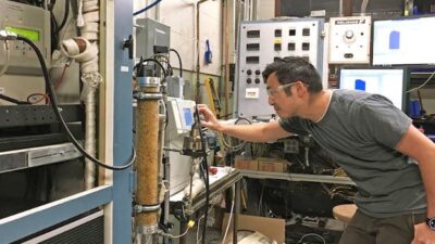 Graduate student Stephen Sakai uses an instrument in the Engine Research Center at UW-Madison to measure the filtration efficiency of different candidate materials for face masks. Courtesy: UW-Madison
