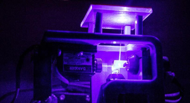 Laser beam transmitting upwards through glass. Courtesy: John Whitehead, Columbia University