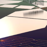 This graphic depicts a stylized rendering of the quantum photonic chip and its assembly process. The bottom half of the image shows a functioning quantum micro-chiplet (QMC), which emits single-photon pulses that are routed and manipulated on a photonic integrated circuit (PIC). The top half of the image shows how this chip is made: Diamond QMCs are fabricated separately and then transferred into the PIC. Courtesy: Noel H. Wan, Massachusetts Institute of Technology (MIT)