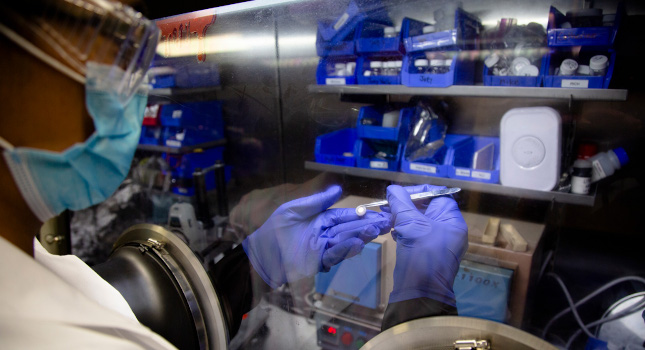 Michael Wang, materials science and engineering Ph.D. candidate, uses a glove box to inspect a lithium metal battery cell in a lab in the Michigan Memorial Phoenix Project building. Courtesy: University of Michigan