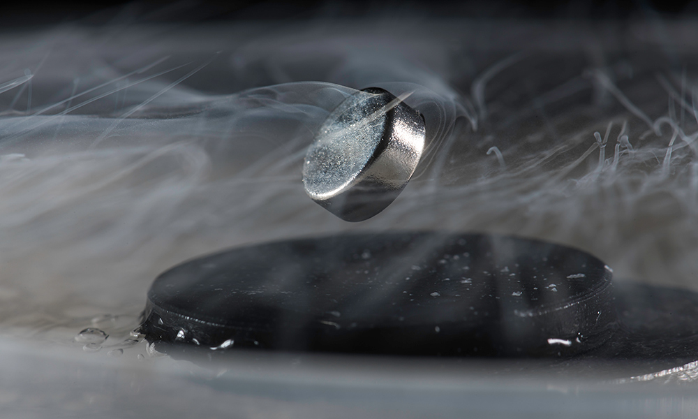 The goal of new research led by Ranga Dias, assistant professor of mechanical engineering and of physics and astronomy, is to develop room temperature superconducting materials. Currently, extreme cold is required to achieve superconductivity, as demonstrated in this photo from Dias's lab, in which a magnet floats above a superconductor cooled with liquid nitrogen. Courtesy: J. Adam Fenster, University of Rochester