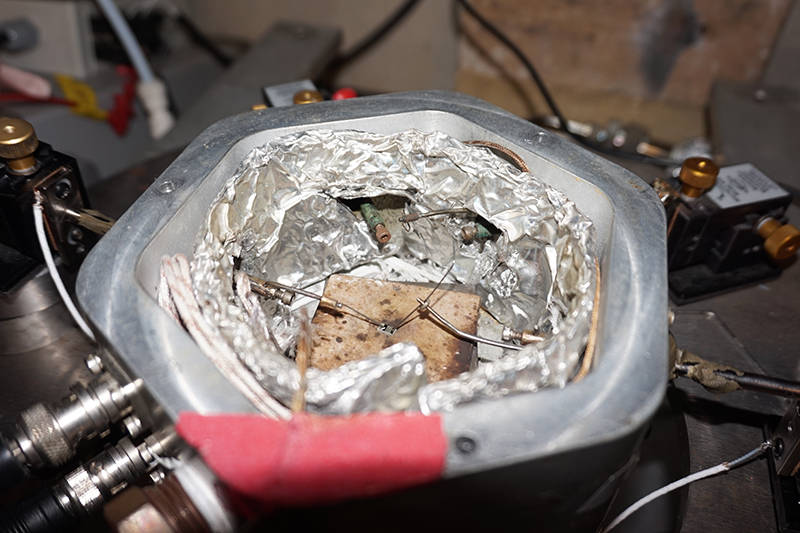 By stimulating this quantum material (tiny gray-and-black striped rectangle, center) with gases, researchers discovered that the material could mimic basic forms of learning found in the sea slug. Courtesy: Kayla Wiles, Purdue University