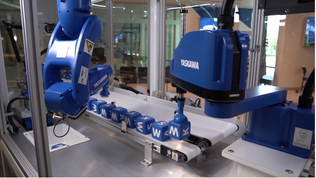 Figure 9: Pick and place with SCARA and 6-axis manipulator. Courtesy: Yaskawa America Inc.