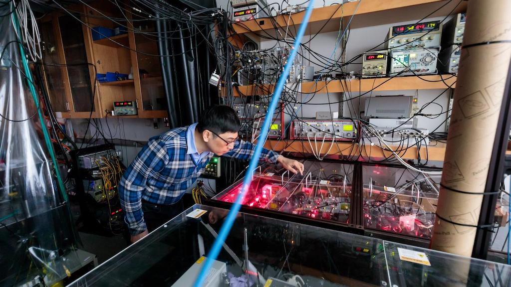 Prof. Cheng Chin adjusts the optics in his laboratory at the University of Chicago. New research by UChicago and Shanxi University discovered a way to simulate superconductivity in twisted bilayer lattices. Courtesy: John Zich, University of Chicago