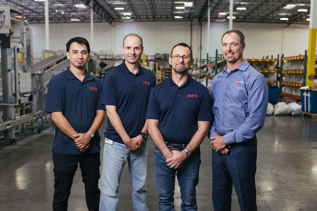 Figure 11: Experts in parcel sortation: (from left) regional service technician Noah Cisneros, sales support manager Shane Potter and CTO Joshua Owens of NPI examine the GenIII Xstream with Doug Schuchart, global material handling & intralogistics manager for Beckhoff. Courtesy: Foreword LLC, NPI, Beckhoff Automation 