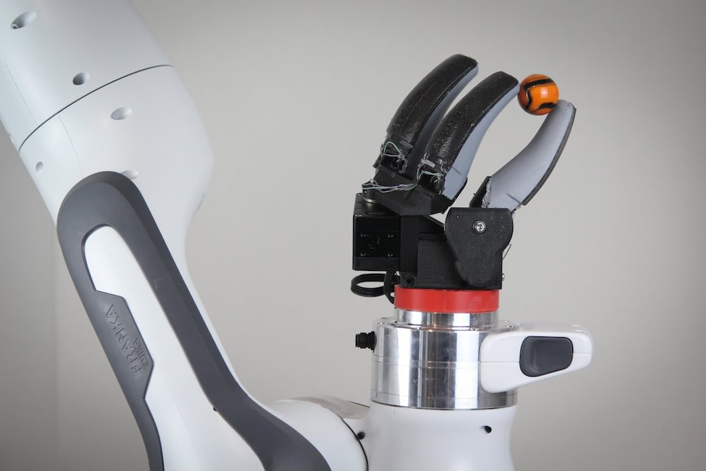 MIT researchers have developed a camera-based touch sensor that is long, curved, and shaped like a human finger. Their device, which provides high-resolution tactile sensing over a large area, could enable a robotic hand to perform multiple types of grasps.