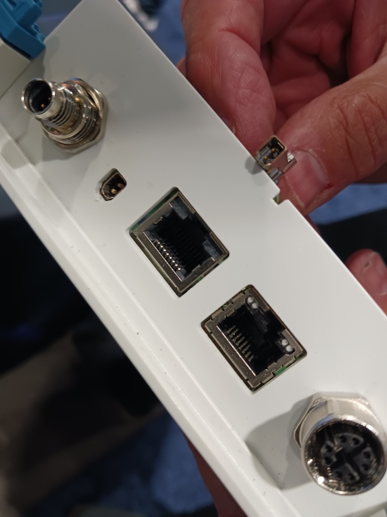 Figure 7: A comparison of the size of Single-Pair Ethernet (SPE, plug is between figure and thumb) with other connectors was part of the Phoenix Contact connector display at the DigiKey booth at the Automate 2024 event by A3, the Association for Advancing Automation, in Chicago. 