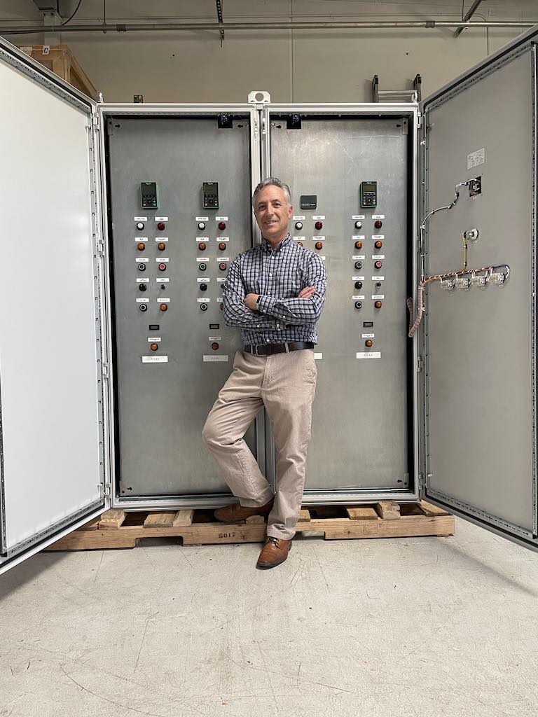 Mike Howard, George T. Hall vice president of system integration, stands in front of GTH panels built in its Nevada UL certified panel shop. He is head of Nevada operations and mentors GTH business development engineers, project managers, technical team/engineers, and production team. Courtesy: George T. Hall