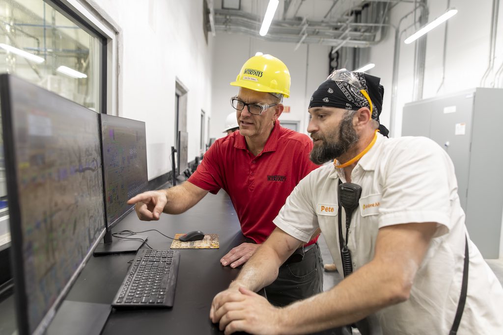 Figure 1: Ardent Mills production worker reviewing the I-Control software with an Interstates team member. This system allows quality control to track what was put in each load to ensure product safety. Courtesy: Interstates
