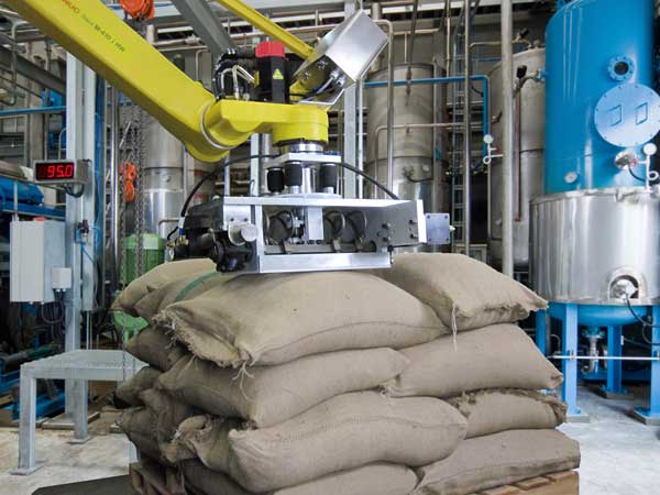 When the end effector is placed on the center of the target bag, pneumatically driven tines emerge to pierce the bag without ripping it. Then the robot lifts the bag and places it on a conveyor. Courtesy: Concept Systems