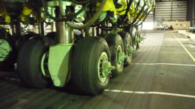 Figure 2. Extending down from the carriage gantry are configurable load modules that simulate the fully loaded wheel assemblies of taxing aircraft.