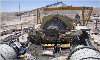 The three huge grinding mills that grind the ore into particles. Each ABB gearless mill drive system comprises a large gearless synchronous motor that is wrapped around the mill like a ring. The power and control equipment of the system is located in a pu
