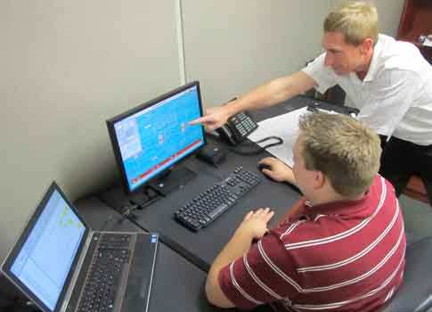 TriCore engineers confer on a client project. Courtesy: TriCore Inc.