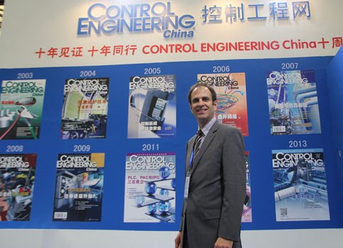 Jim Langhenry, Control Engineering publisher, CFE Media Group co-founder, and president group publisher, is shown with a display representing 10 years of Control Engineering China. Courtesy: Control Engineering China