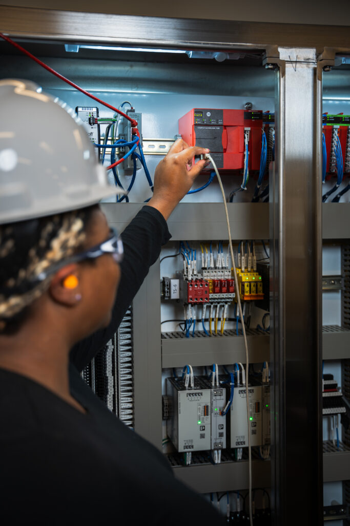 A controls engineer performing testing.